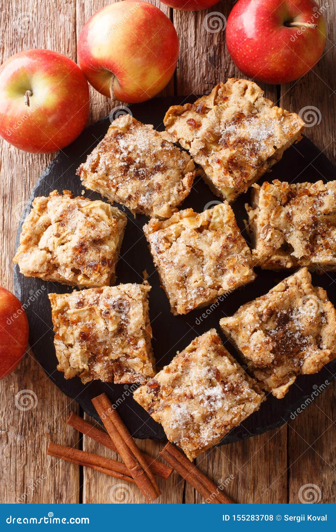 appleÃÂ cinnamonÃÂ blondies close-up on a slate board. vertical top view